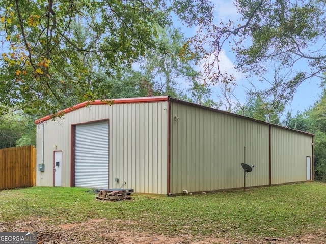 view of shed / structure with a lawn and a garage