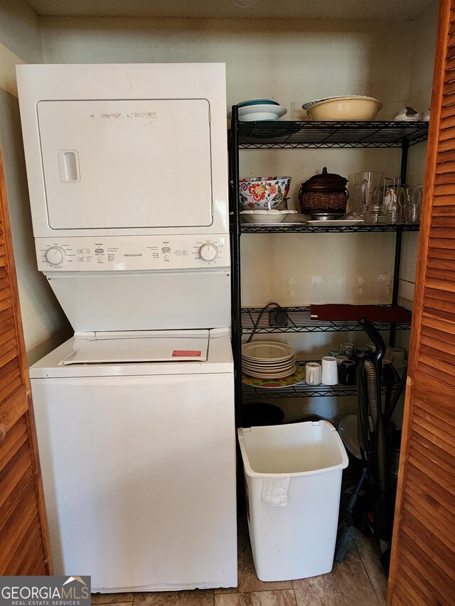 laundry area with stacked washer and clothes dryer