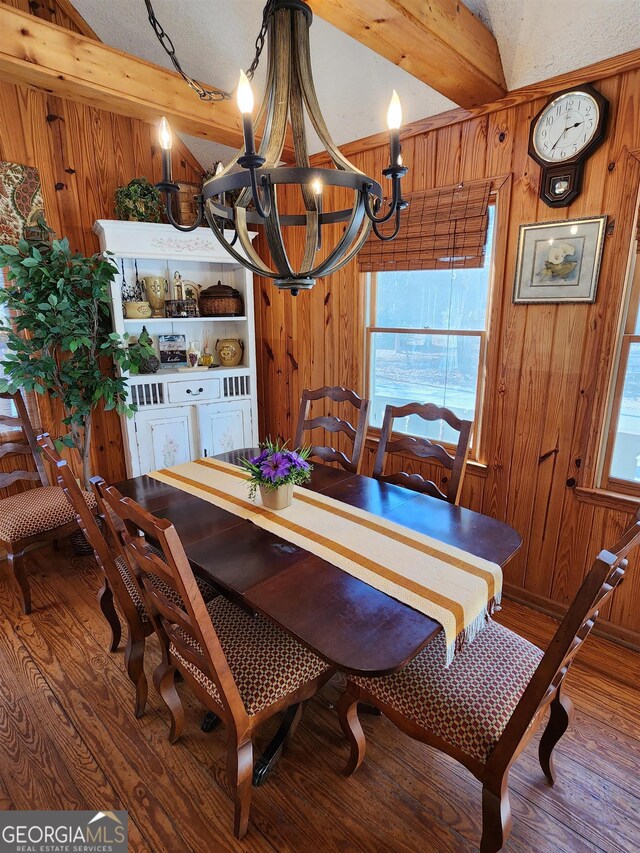 dining space featuring a textured ceiling, hardwood / wood-style flooring, and a healthy amount of sunlight