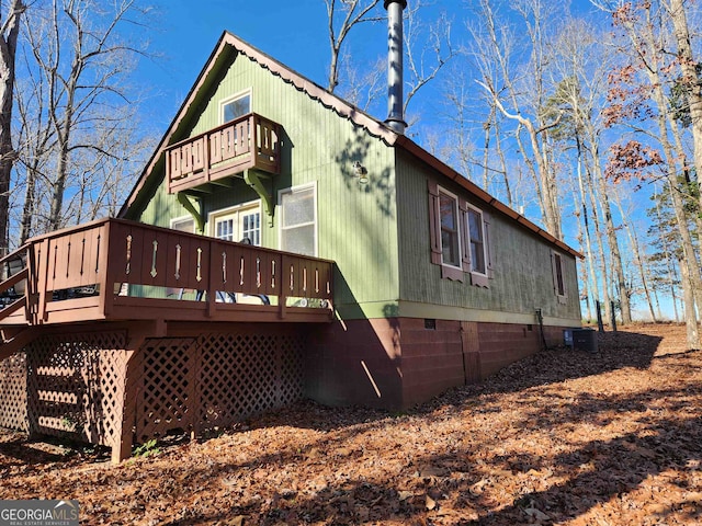 rear view of house featuring central AC unit and a deck