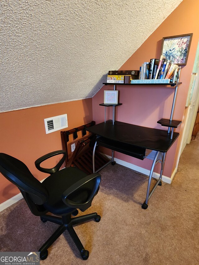 office space featuring a textured ceiling, vaulted ceiling, and carpet