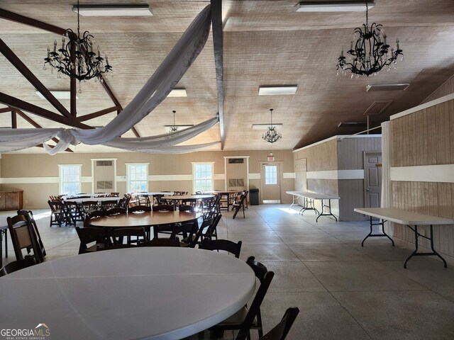 dining space featuring a notable chandelier and lofted ceiling