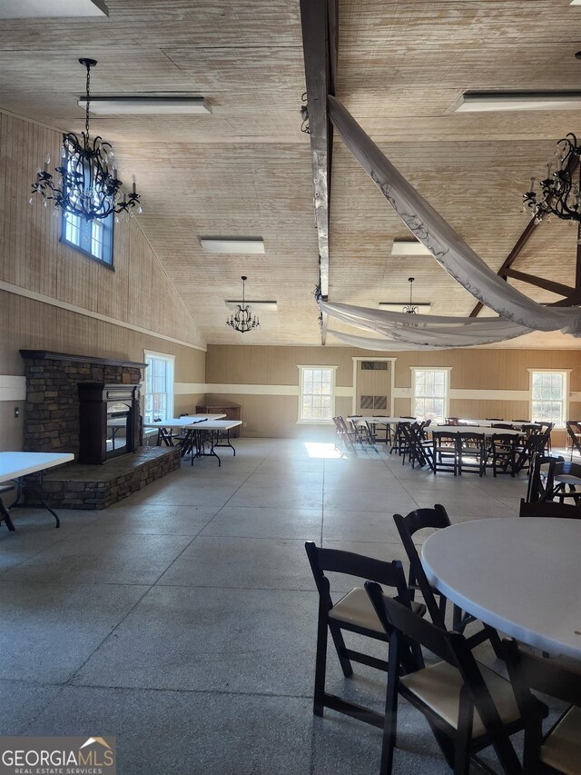 unfurnished dining area with a healthy amount of sunlight, a high ceiling, and a chandelier