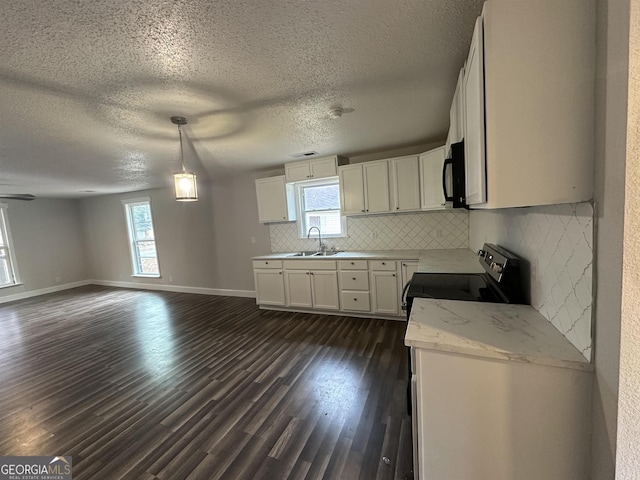 kitchen with dark hardwood / wood-style floors, pendant lighting, white cabinetry, sink, and electric stove