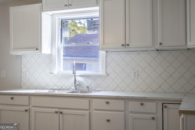 kitchen featuring a healthy amount of sunlight, sink, and white cabinets