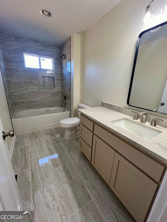 full bathroom featuring vanity, toilet, and tiled shower / bath combo