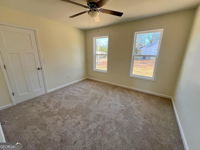 unfurnished room featuring ceiling fan and light colored carpet