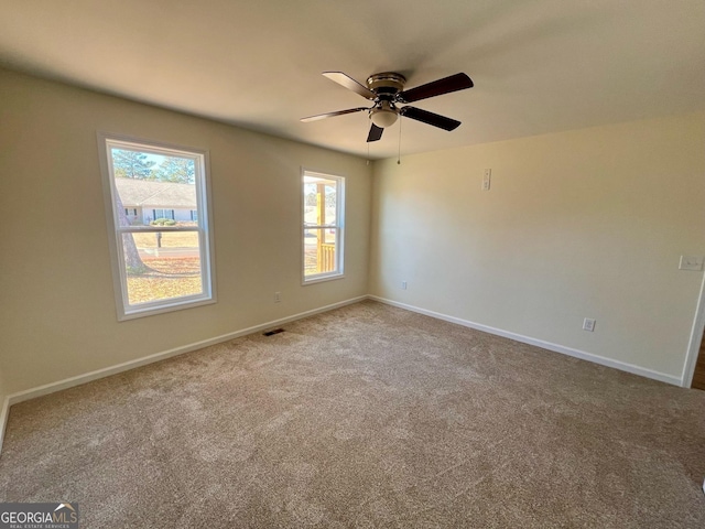 empty room featuring carpet and ceiling fan