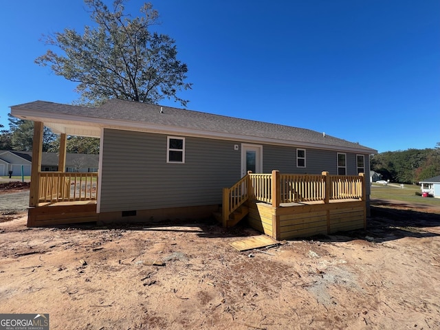 back of property with a wooden deck