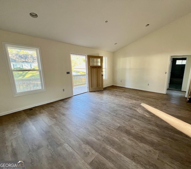 interior space with vaulted ceiling and dark hardwood / wood-style floors