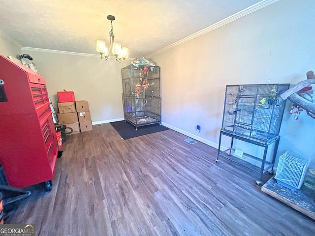 interior space featuring ornamental molding, dark wood-type flooring, and a chandelier