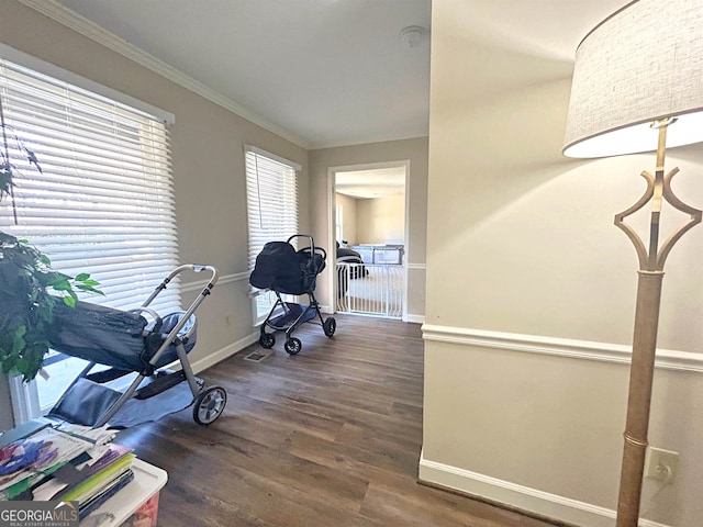 workout room with crown molding and dark hardwood / wood-style floors