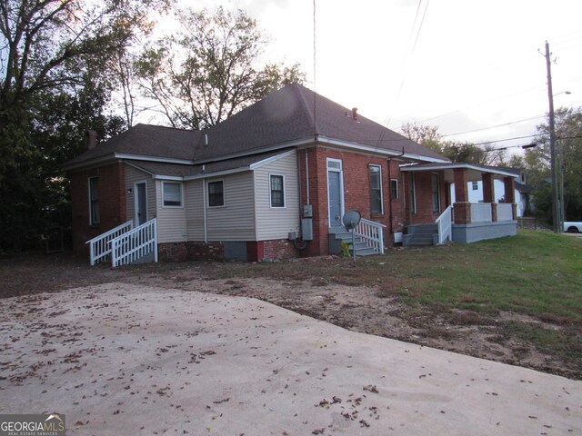 4154 Houston Ave, Macon, GA 31206 - view of property exterior featuring central AC unit, a shingled roof, and brick siding