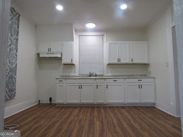 4154 Houston Ave, Macon, GA 31206 - kitchen featuring baseboards, dark wood-style floors, white cabinetry, and under cabinet range hood