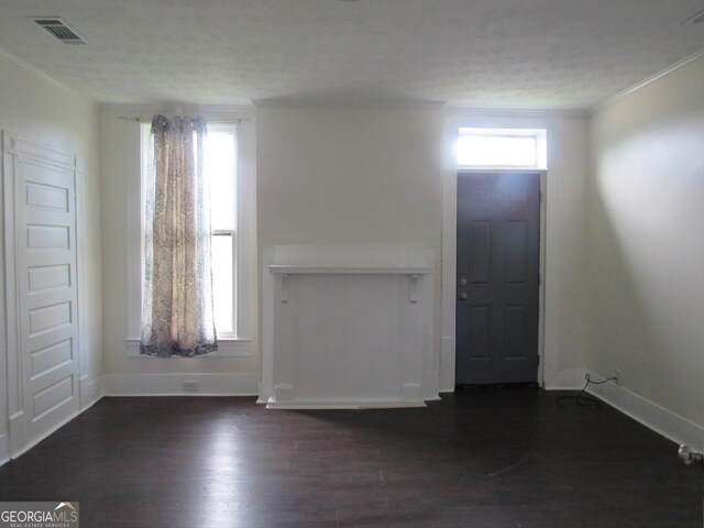 4154 Houston Ave, Macon, GA 31206 - entryway with dark wood finished floors, visible vents, baseboards, a textured ceiling, and ornamental molding