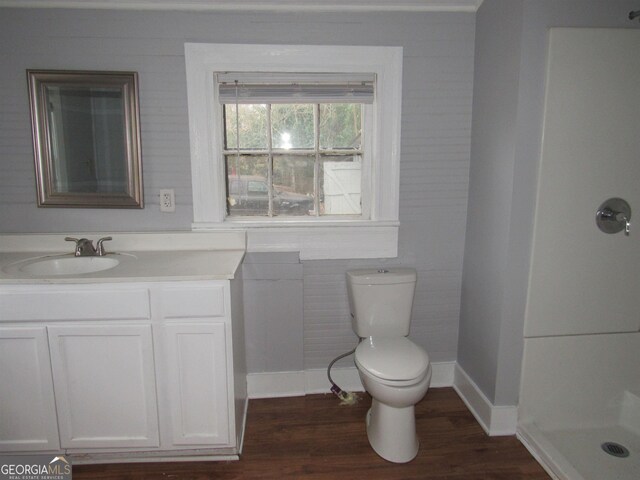 4154 Houston Ave, Macon, GA 31206 - bathroom featuring toilet, baseboards, vanity, wood finished floors, and a shower