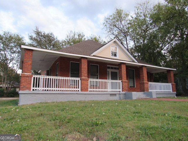 4154 Houston Ave, Macon, GA 31206 - farmhouse with a front yard, brick siding, covered porch, and crawl space