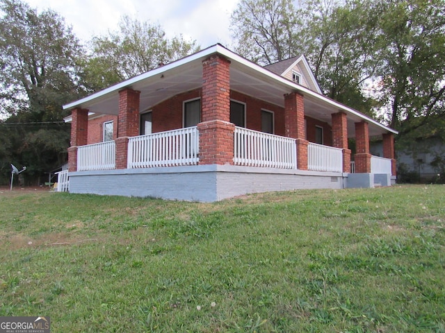 4154 Houston Ave, Macon, GA 31206 - view of front of home featuring brick siding, a front yard, and a porch