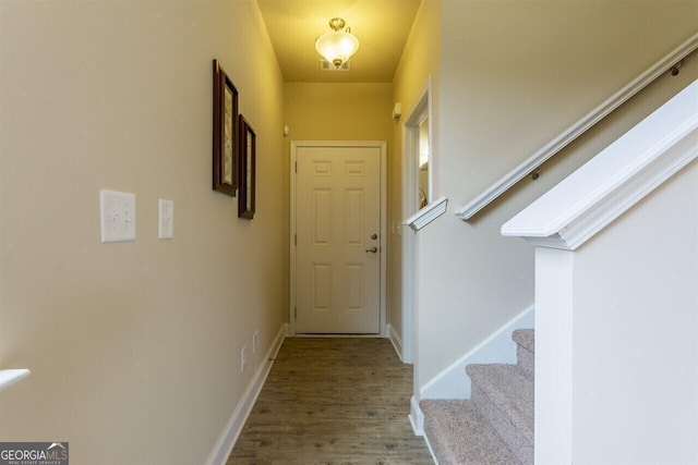 doorway to outside with wood-type flooring