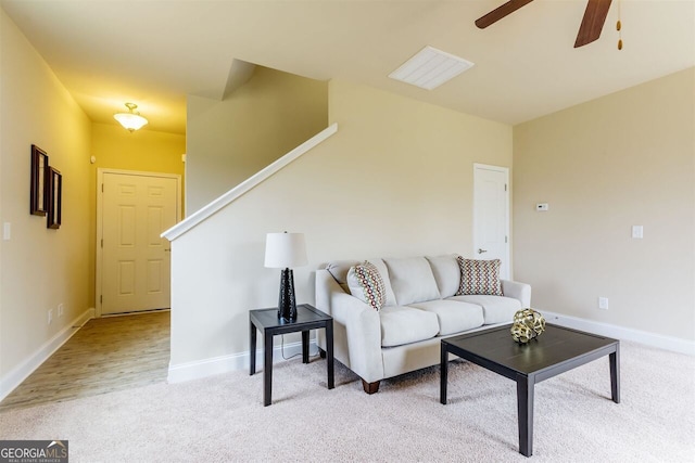 living room with ceiling fan and light colored carpet