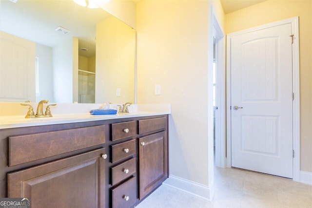 bathroom featuring dual sinks, tile floors, and oversized vanity