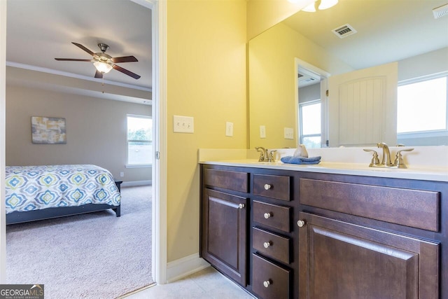 bathroom featuring a healthy amount of sunlight, dual bowl vanity, tile floors, and ceiling fan