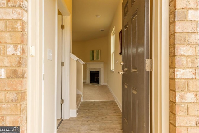 corridor with light wood-type flooring