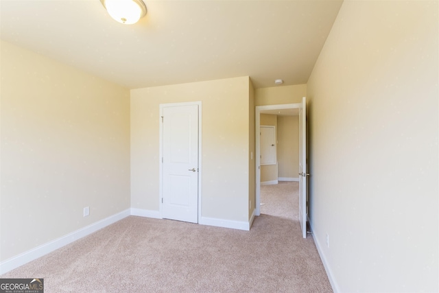 unfurnished bedroom with light carpet