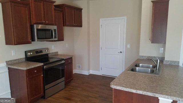 kitchen with sink, stainless steel appliances, and dark hardwood / wood-style floors