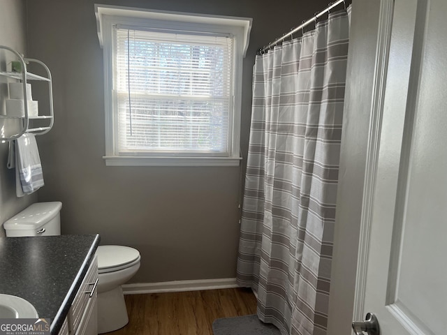 bathroom with vanity, hardwood / wood-style floors, a shower with shower curtain, and toilet