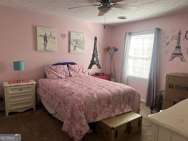 carpeted bedroom featuring ceiling fan and a textured ceiling