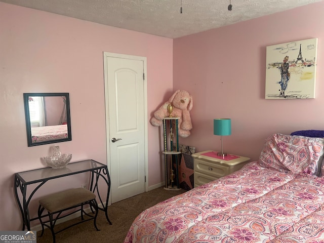 bedroom featuring carpet flooring and a textured ceiling