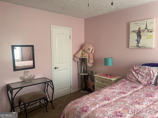 carpeted bedroom featuring a textured ceiling