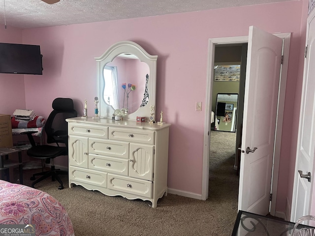 carpeted bedroom featuring a textured ceiling