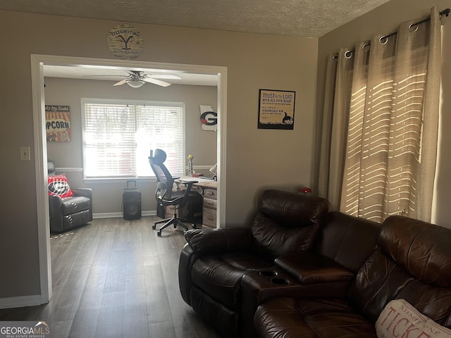 office area featuring wood-type flooring, ceiling fan, and a textured ceiling