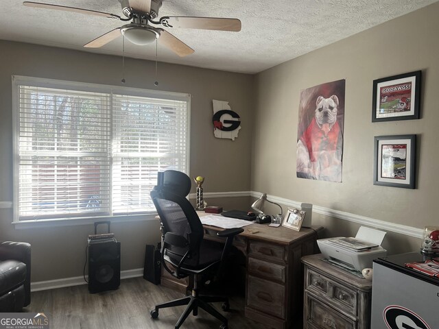 home office featuring wood-type flooring, a textured ceiling, and ceiling fan