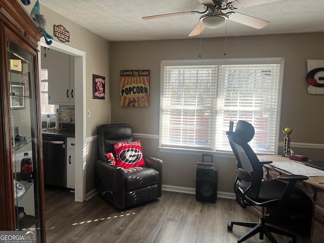 home office featuring hardwood / wood-style flooring, a textured ceiling, and ceiling fan