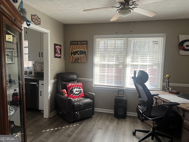 office featuring hardwood / wood-style floors, a textured ceiling, and ceiling fan