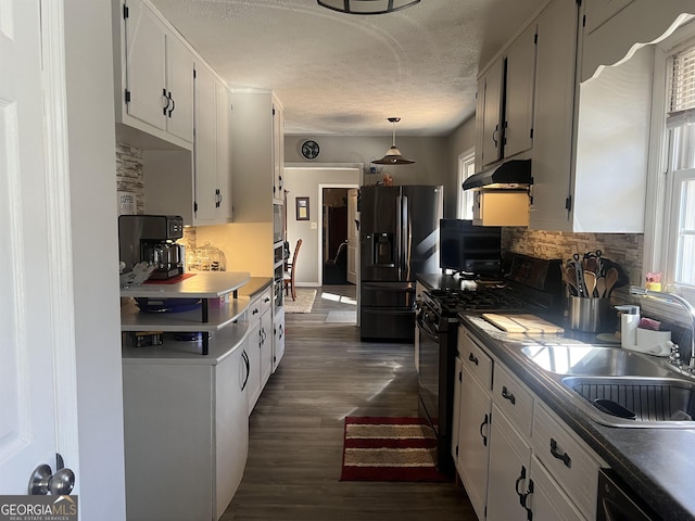 kitchen with white cabinetry, sink, pendant lighting, and black appliances