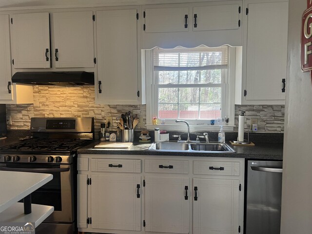 kitchen with decorative backsplash, sink, appliances with stainless steel finishes, and white cabinets