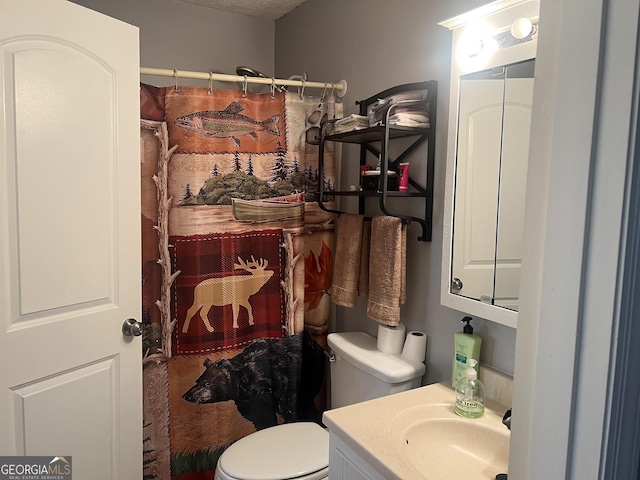 bathroom with vanity, a shower with shower curtain, and toilet