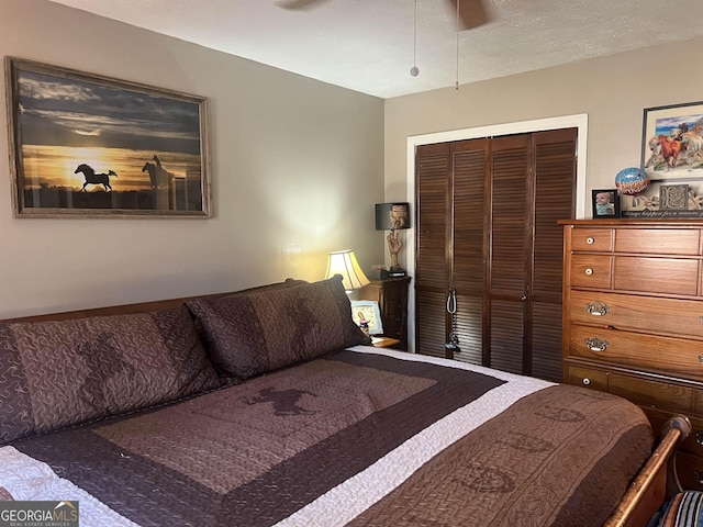 bedroom with ceiling fan and a closet