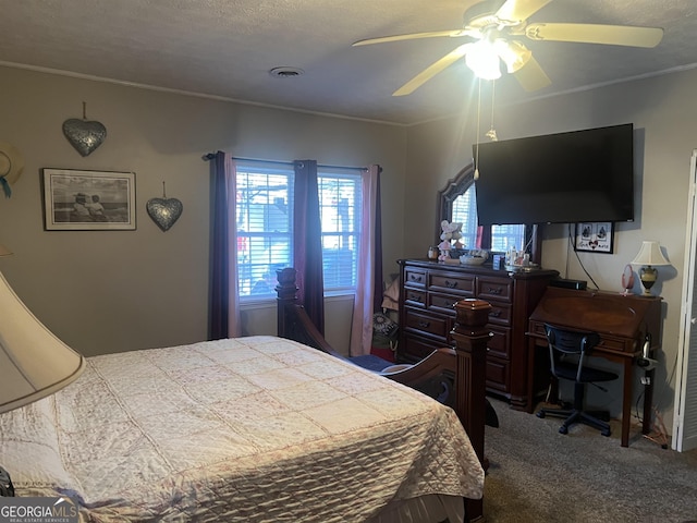 bedroom with crown molding, ceiling fan, carpet floors, and a textured ceiling