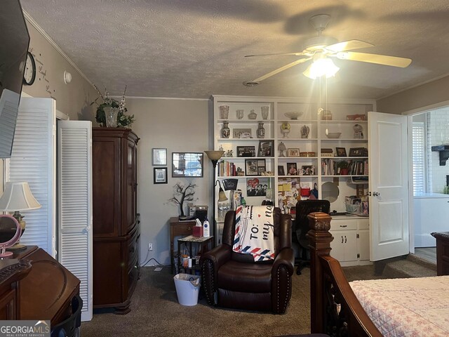 carpeted bedroom featuring a textured ceiling and ceiling fan