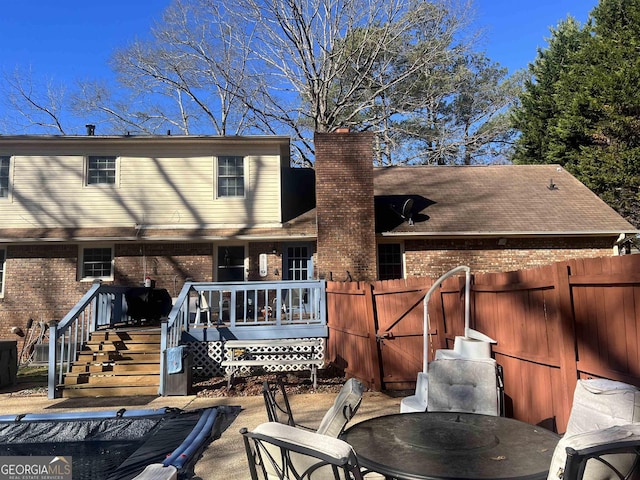 back of house with a patio area and a deck