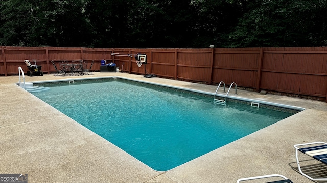 view of swimming pool with a patio