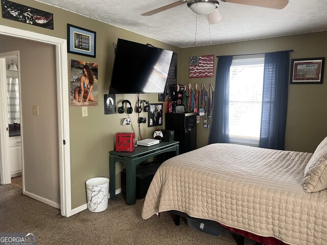 carpeted bedroom with a textured ceiling and ceiling fan