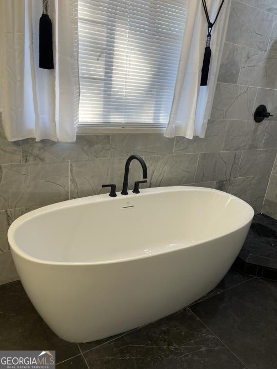 bathroom featuring tile flooring and tile walls