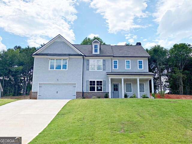 view of front of property with a garage and a front yard