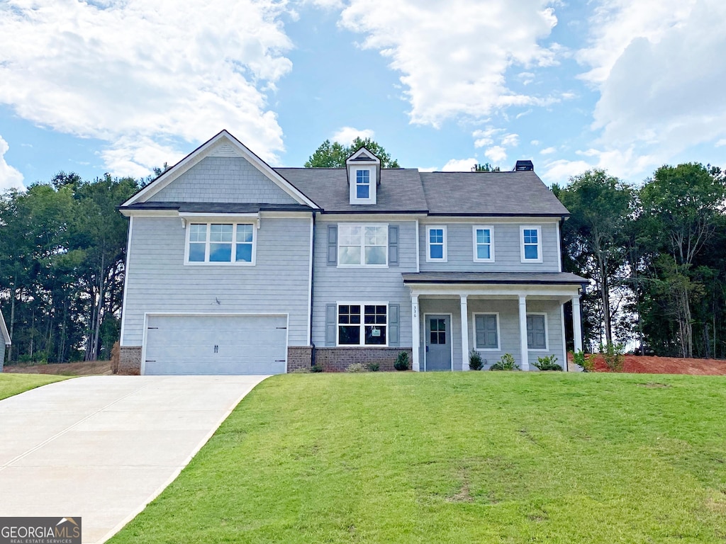 view of front of home featuring a front yard and a garage